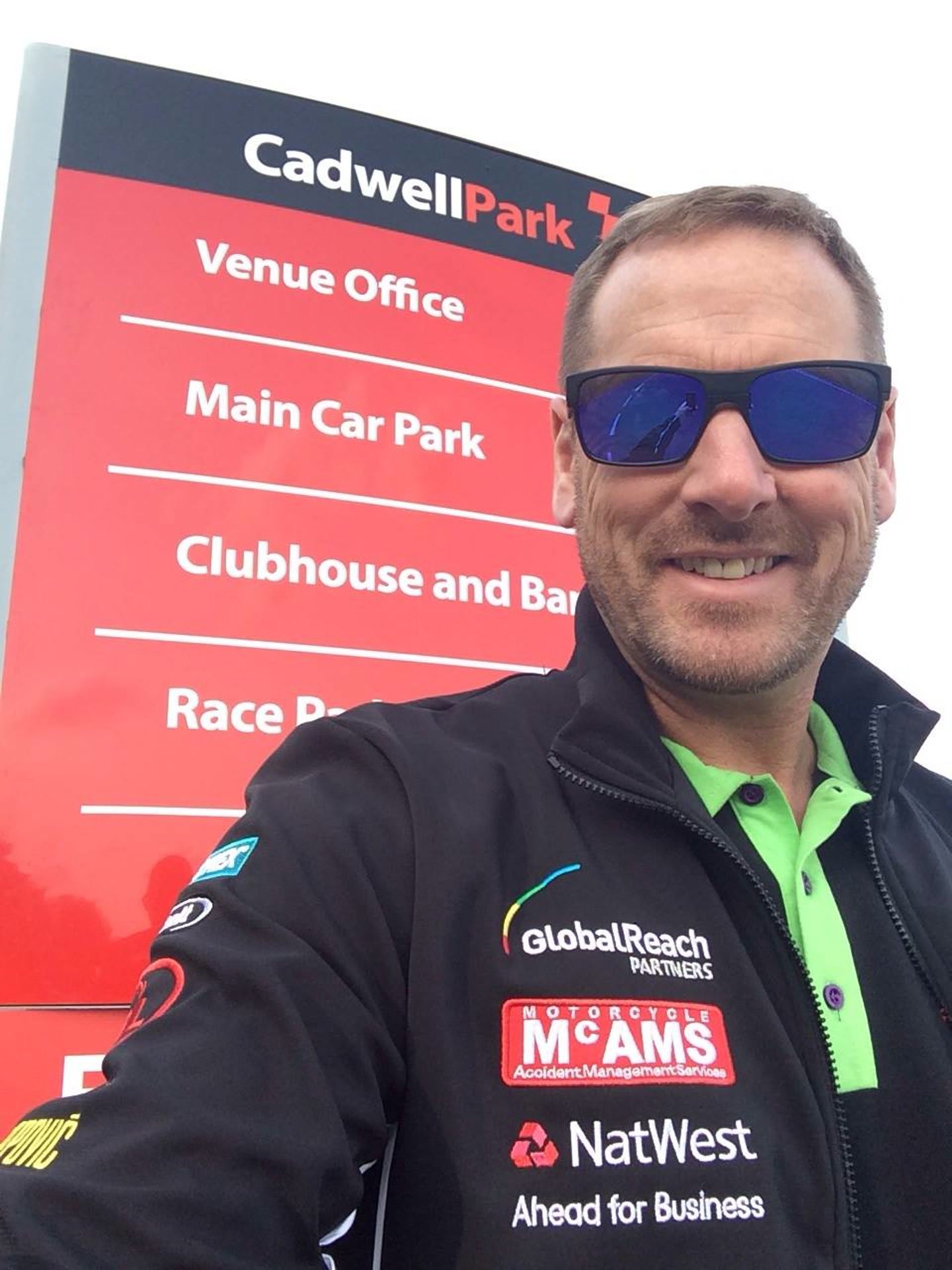 Selfie at the Cadwell Park circuit entrance in team jacket