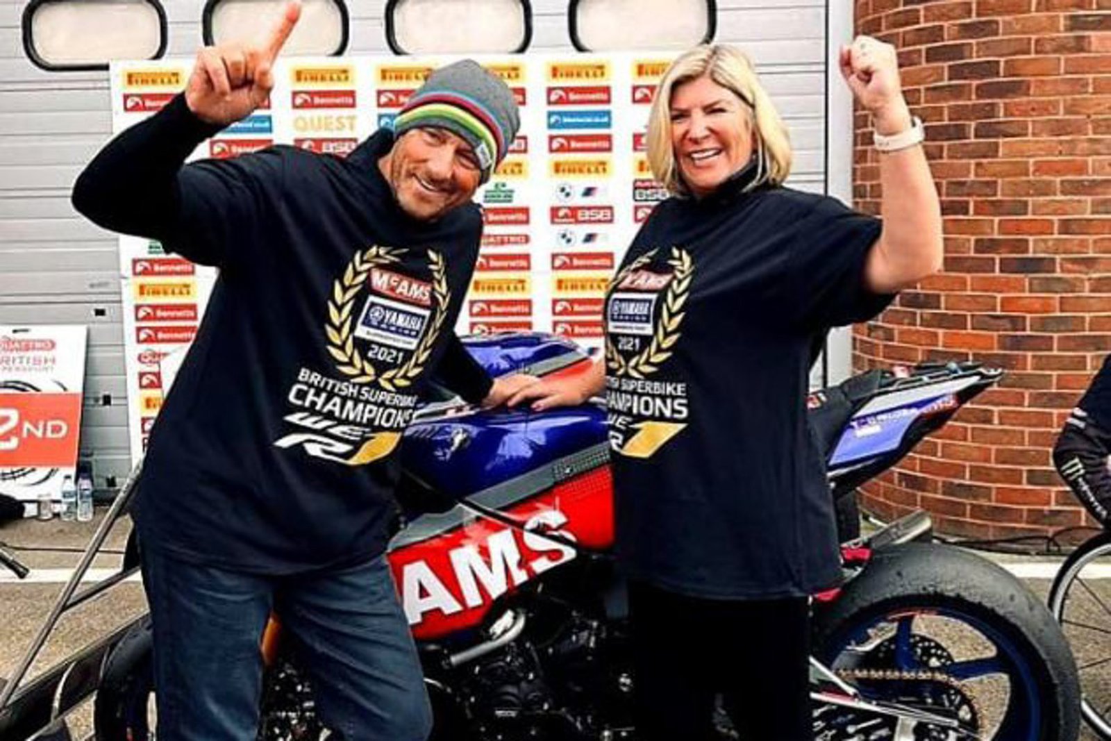 Celebrating in British Superbike Champions 2021 shirts beside the race bike