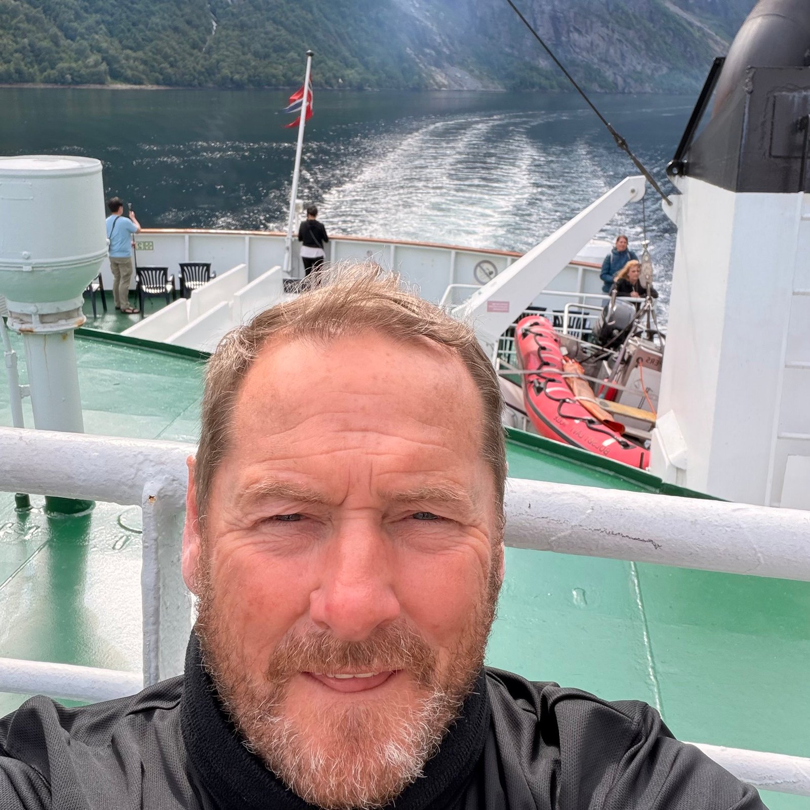 Selfie on a ferry deck in a steep sided fjord