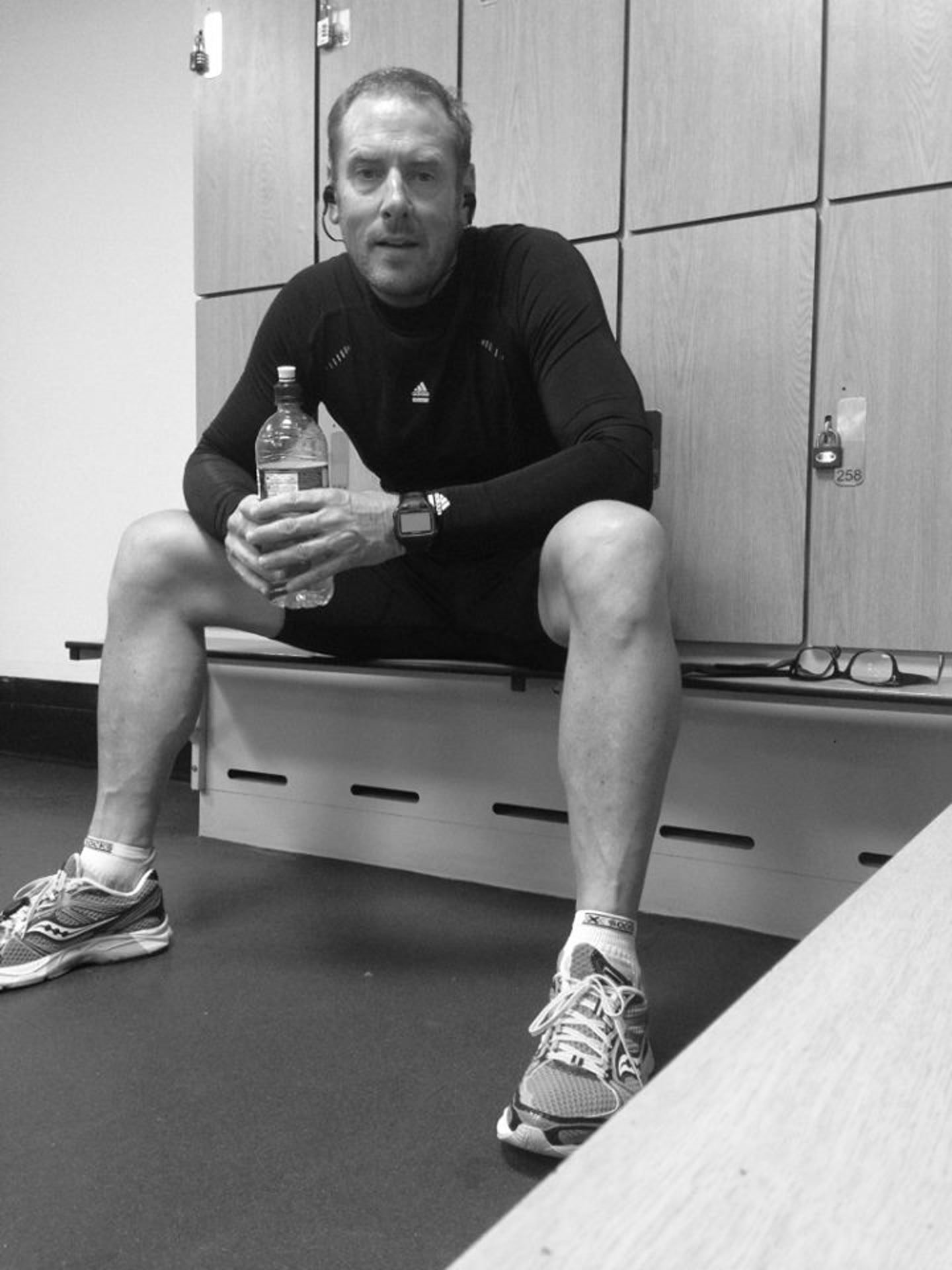 Black and white photo sitting on a locker room bench after training