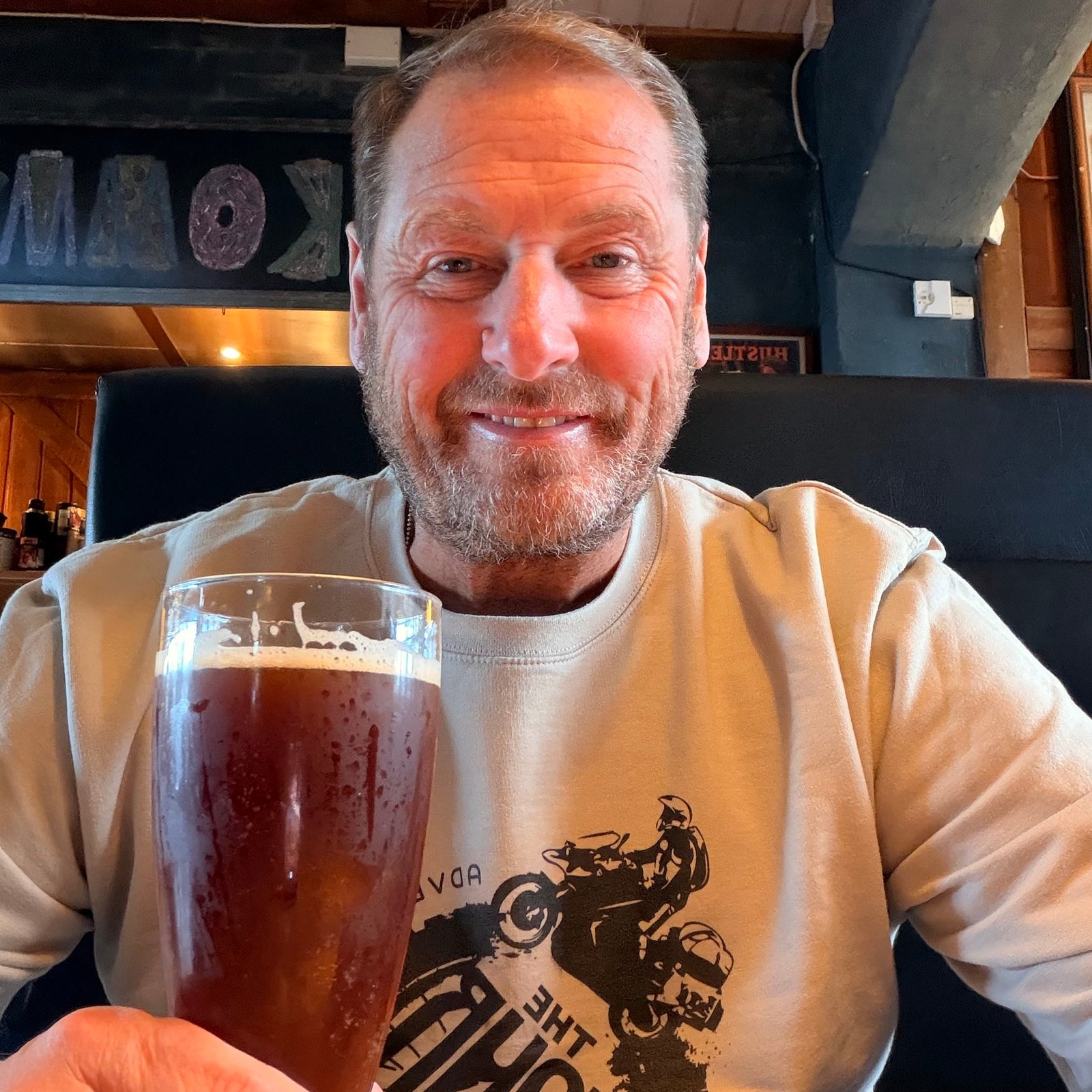 Smiling selfie with a well earned pint in a pub