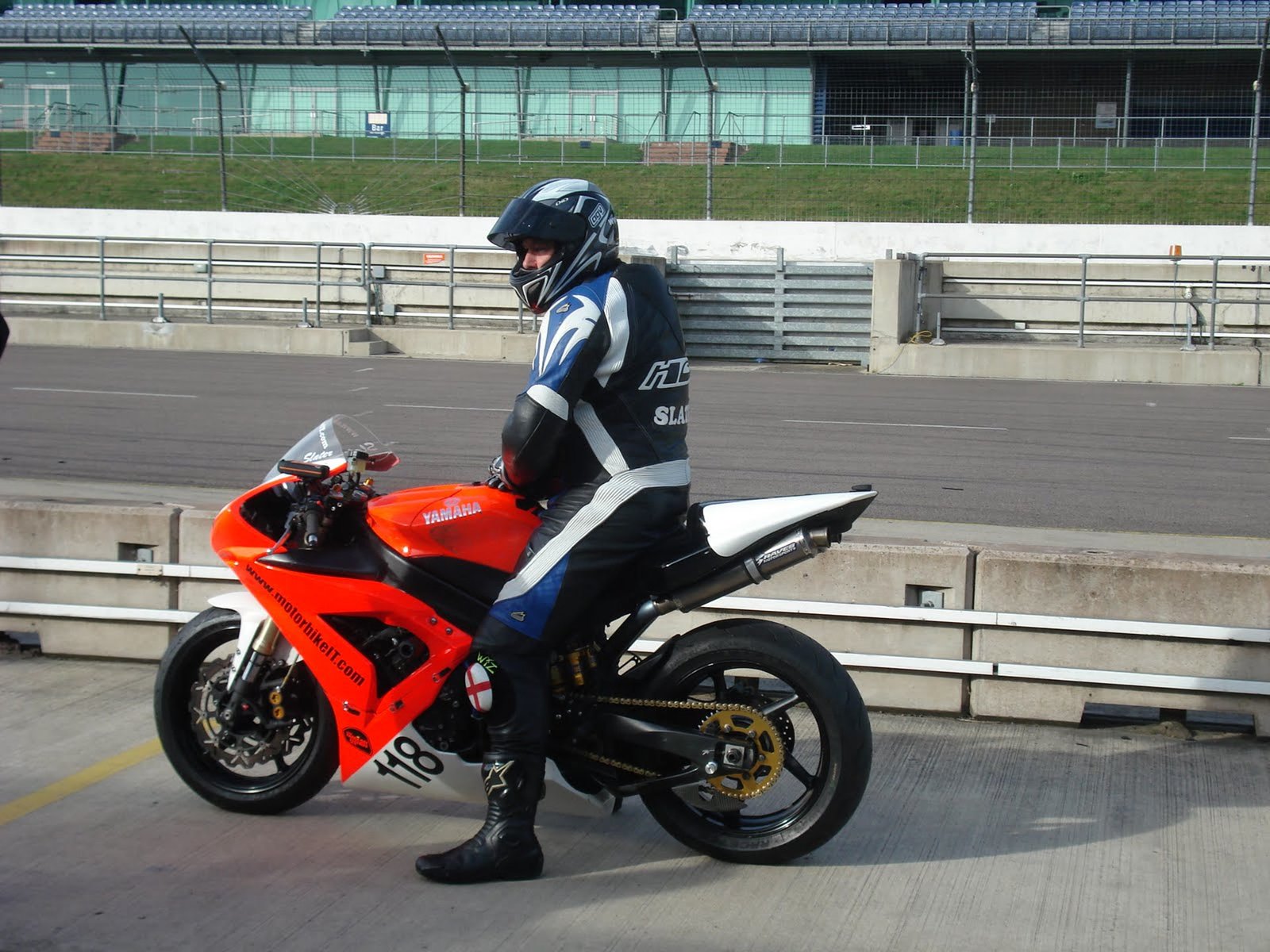 Sitting on a red race Yamaha number 118 in pit lane